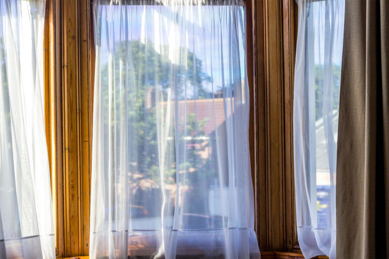 Old, vintage windows with white net curtains